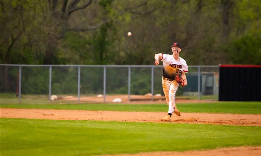 A Ravenwood High baseball player throws the ball.